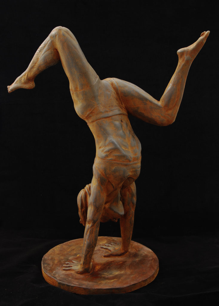Sculpture of female athlete holding a handstand pose