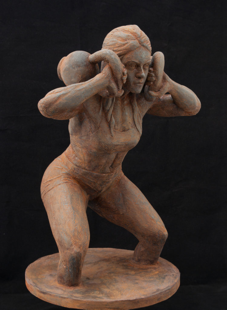 Sculpture of woman lifting two kettlebells.  She rotates them onto her shoulders as she has held the weight so long, it has become a burden.