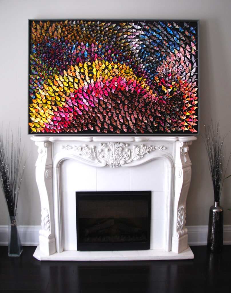 1000 Origami cranes on wood panel over mantle